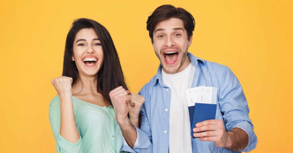 Happy travelers holding passports and boarding passes, representing successful indonesian visa approval and stress-free travel.