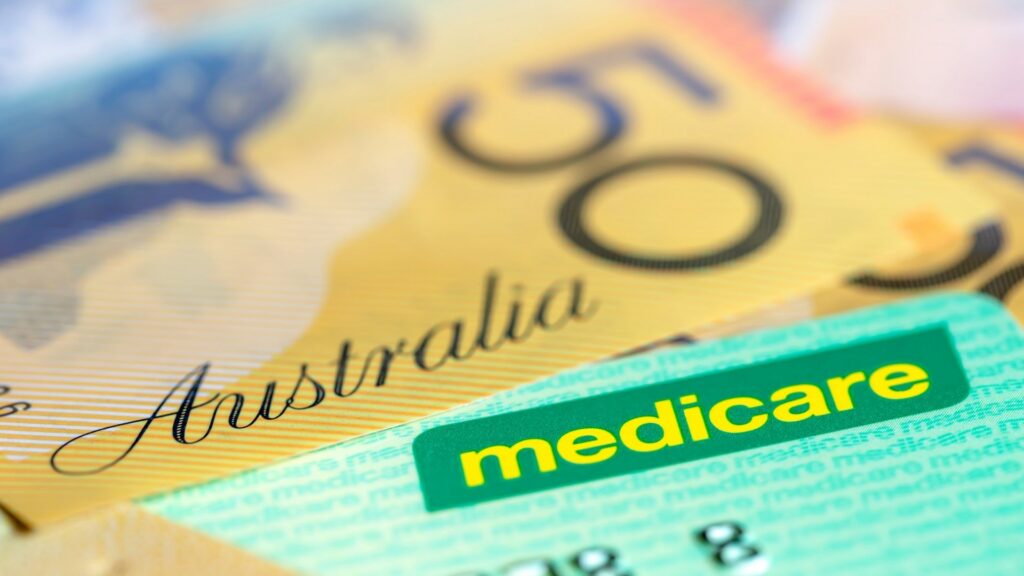 Australian medicare card beside australian banknotes, representing medicare coverage when moving from australia to bali.