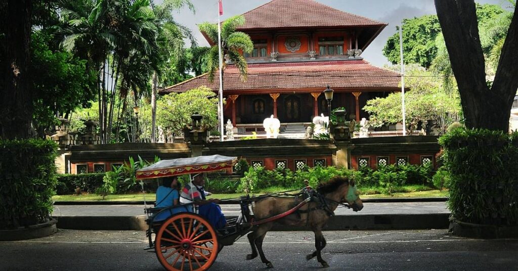 Denpasar street with a traditional horse cart passing Bali Museum. Central, cultural, convenient.