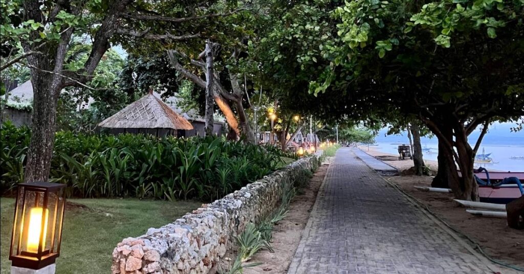 Sanur’s shaded beachfront promenade, flat walking path beside calm water, ideal for daily strolls.
