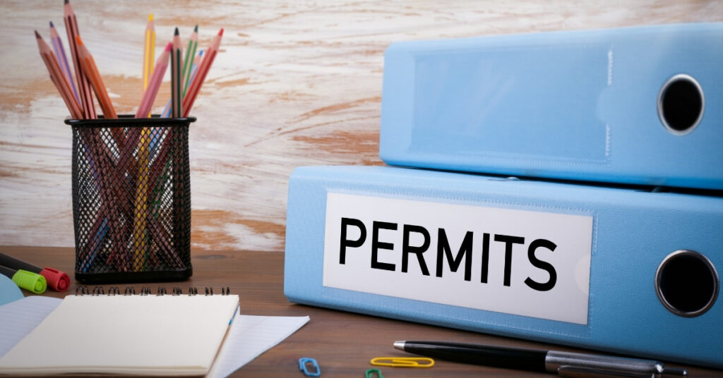 Permit documents and office binders showing paperwork needed for indonesia building permits