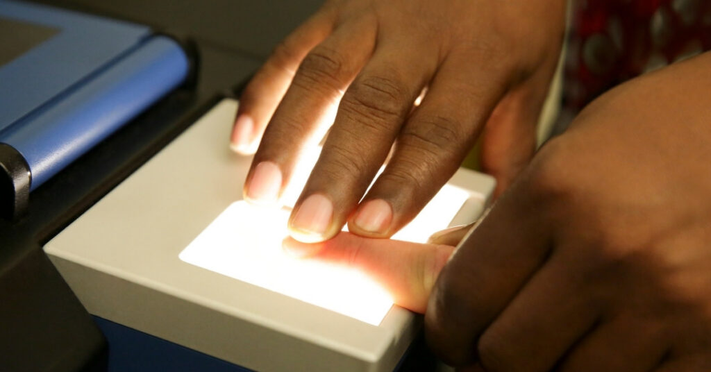 Close-up of a fingerprint scan during indonesian immigration biometrics for a kitap extension.