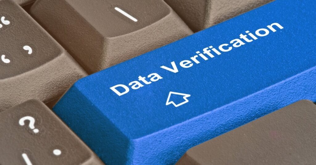 Close-up of blue “data verification” keyboard key symbolising fixing indonesia e-visa waiting verification status online.