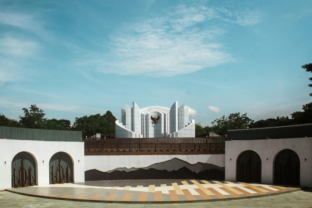 Indonesia's ministry of law and human rights building in jakarta, featuring garuda emblem and modern white architecture under a blue sky.