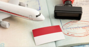 Indonesia visa on arrival, passport stamp, indonesian flag, and airplane on documents.