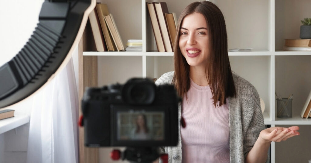 Content creator speaking to a camera with a ring light in a home studio, showing different indonesia visa options for youtubers.