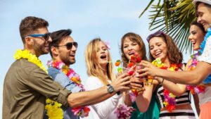 Group of young adults enjoying drinks at a tropical gathering, representing the social lifestyle australians may find in bali.