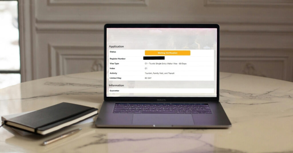 Laptop screen showing indonesia c1 tourist e-visa application page with status highlighted as waiting verification.