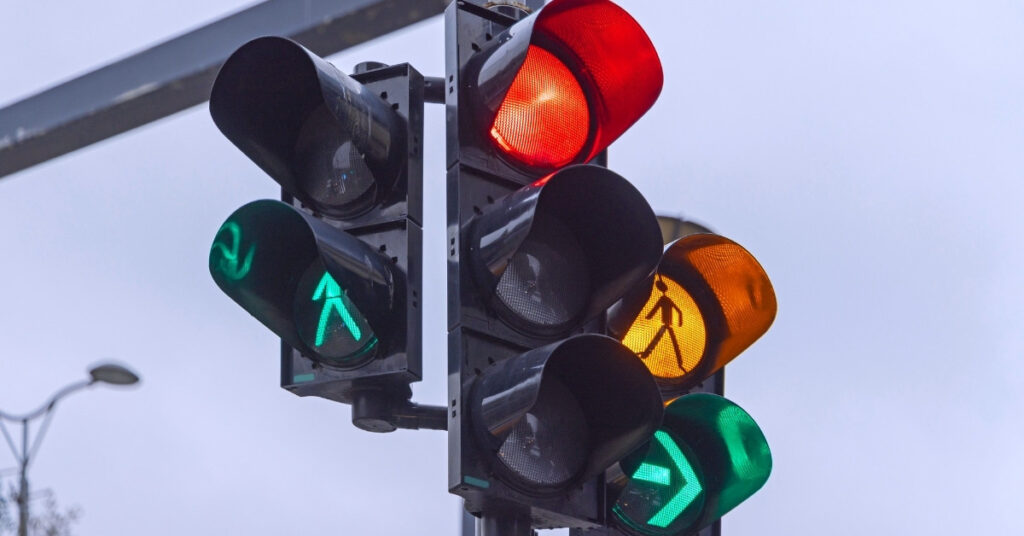 Traffic lights showing red, amber and green arrows, bali traffic rules and signals for scooter riders.