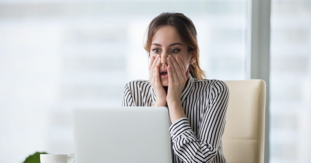 Common Indonesia visa on arrival mistakes for families. Stressed traveler at laptop planning a trip.