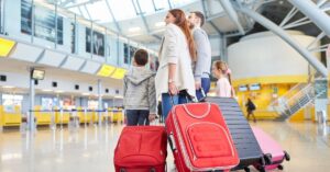 Family at airport with suitcases, step-by-step guide to visa on arrival for families in indonesia.