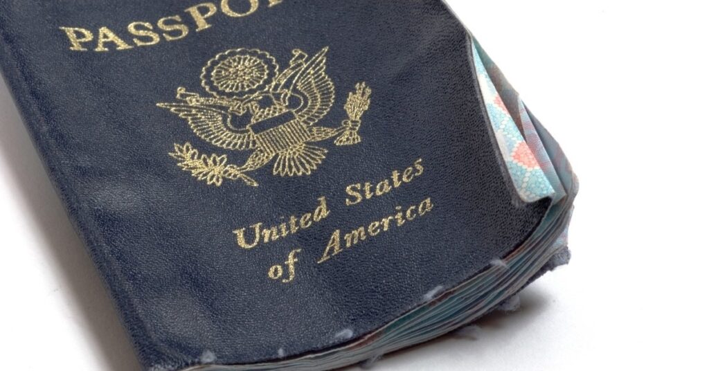 Damaged passport with frayed cover, risk of refusal for Indonesia visa on arrival.