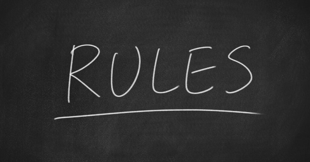 “RULES” on a chalkboard, reminder to check Indonesia immigration and VOA updates before flying.