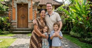 Smiling family standing outside a balinese-style home, representing indonesian diaspora and mixed-nationality families who may qualify for gci.