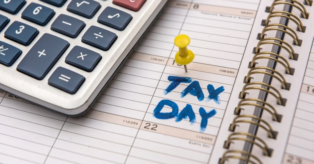 Calculator on a calendar marked tax day, illustrating deadlines and important dates for tax for expats in indonesia.